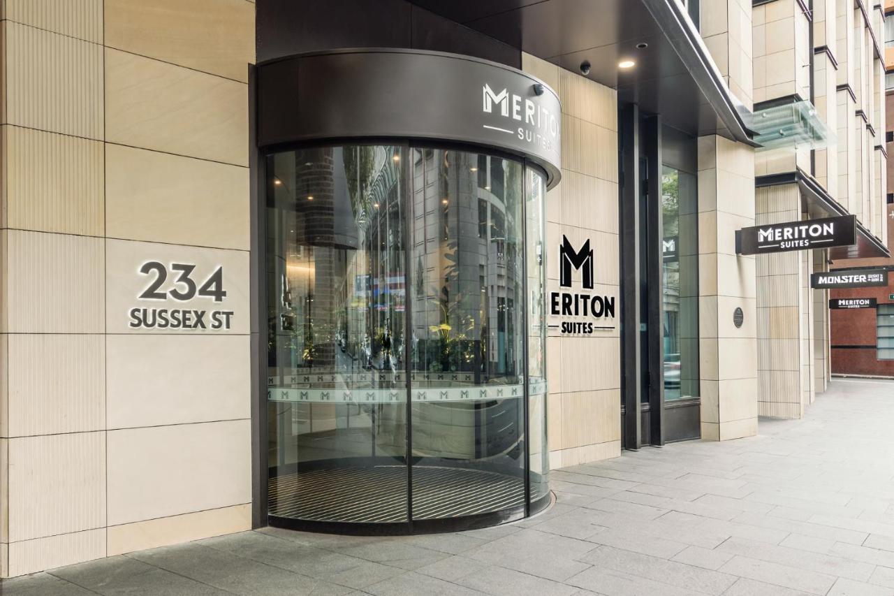 Meriton Suites Sussex Street, Сидни Екстериор снимка The photo shows the entrance of a building located at 234 Sussex Street. It features a modern glass revolving door, alongside a sign indicating "Meriton Suites." The facade is characterized by a combination of stone and glass elements, reflecting a c